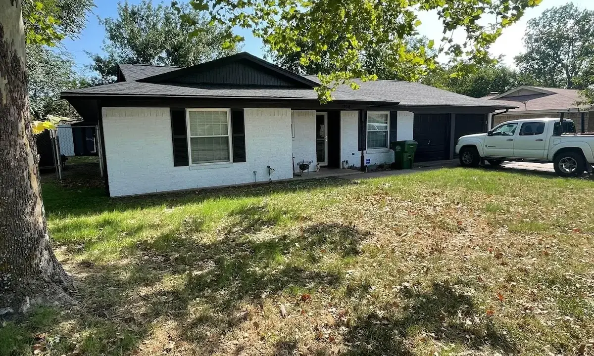 Professional roofing crew working on a residential roof in La Follette